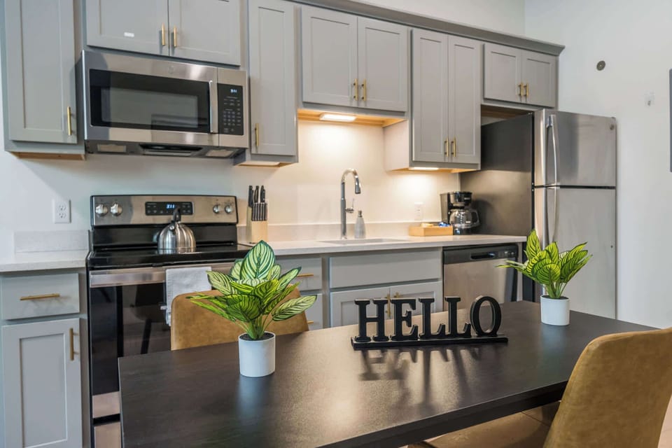 Kitchen: Fully equipped kitchen featuring stainless steel appliances and modern dining area perfect for gatherings.