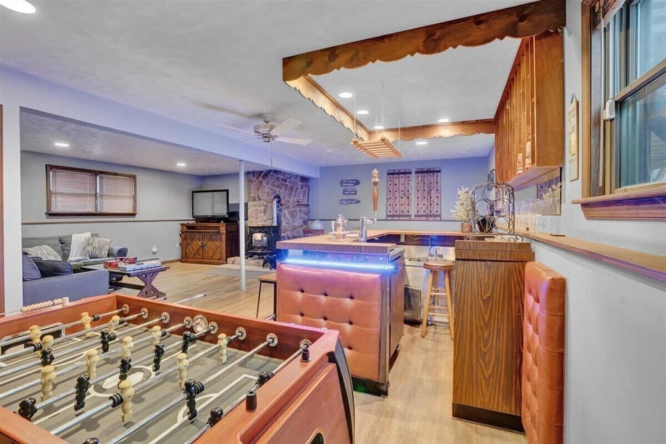 The Ultimate Rec Room – A dynamic game and bar area with glowing LED lighting, creating the perfect setting for casual gatherings and competitive play.