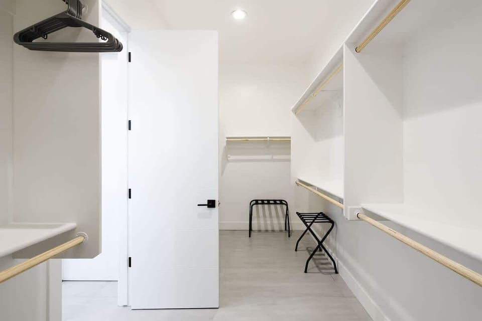 Primary Bathroom featuring a dual vanity, Large Stand-in Shower, Bathtub, and Large Walk-in Closet.