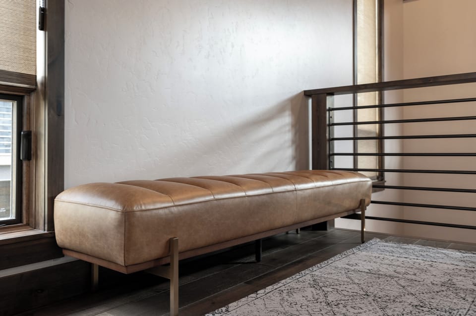 Entry way with leather upholstered bench.