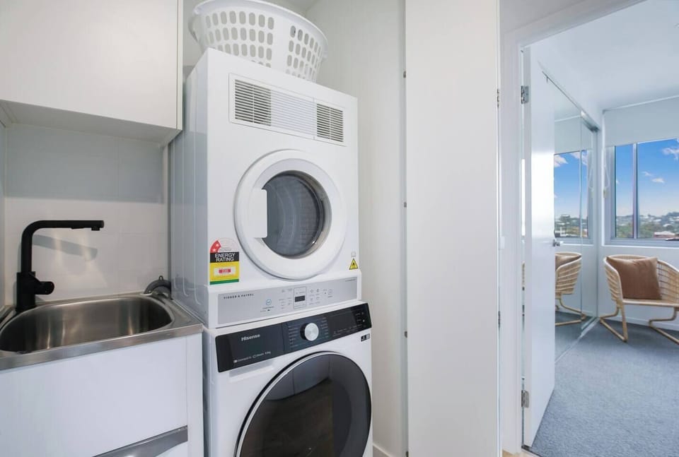 Private laundry facilities include a washing machine, dryer and basin. 