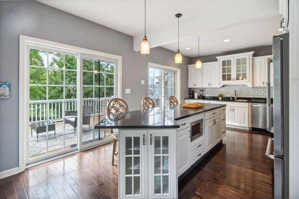Bright fully equipped kitchen with island and deck access