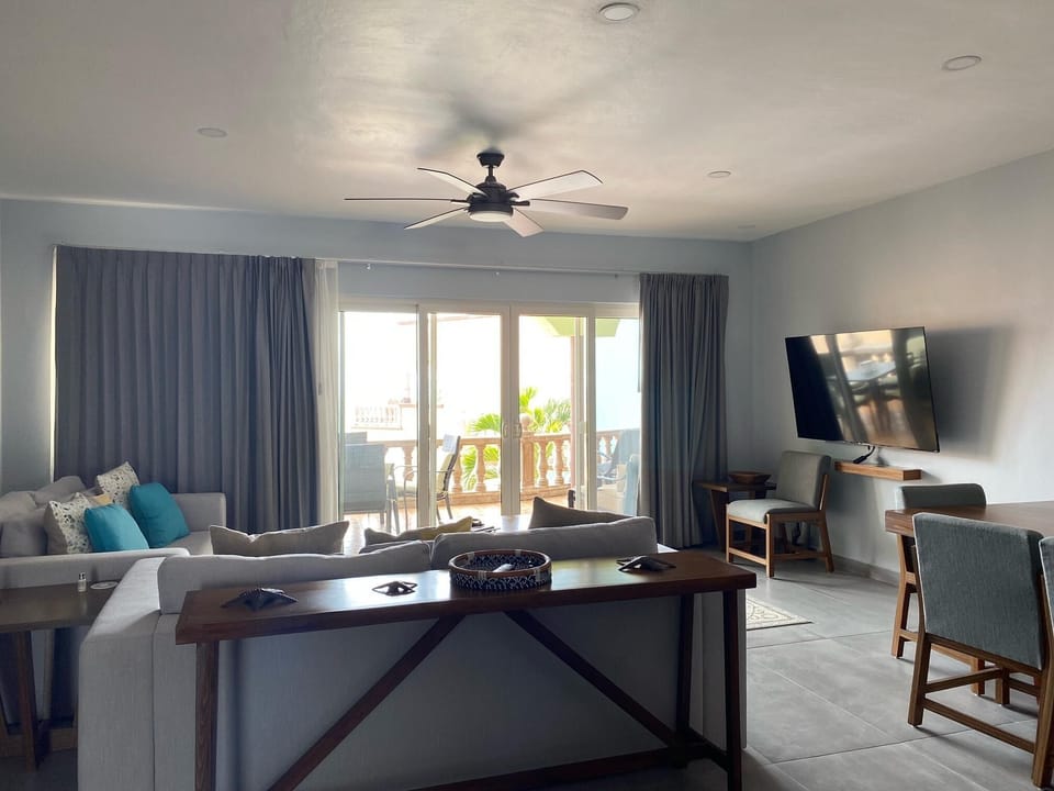 Spacious living room with cozy seating and balcony views