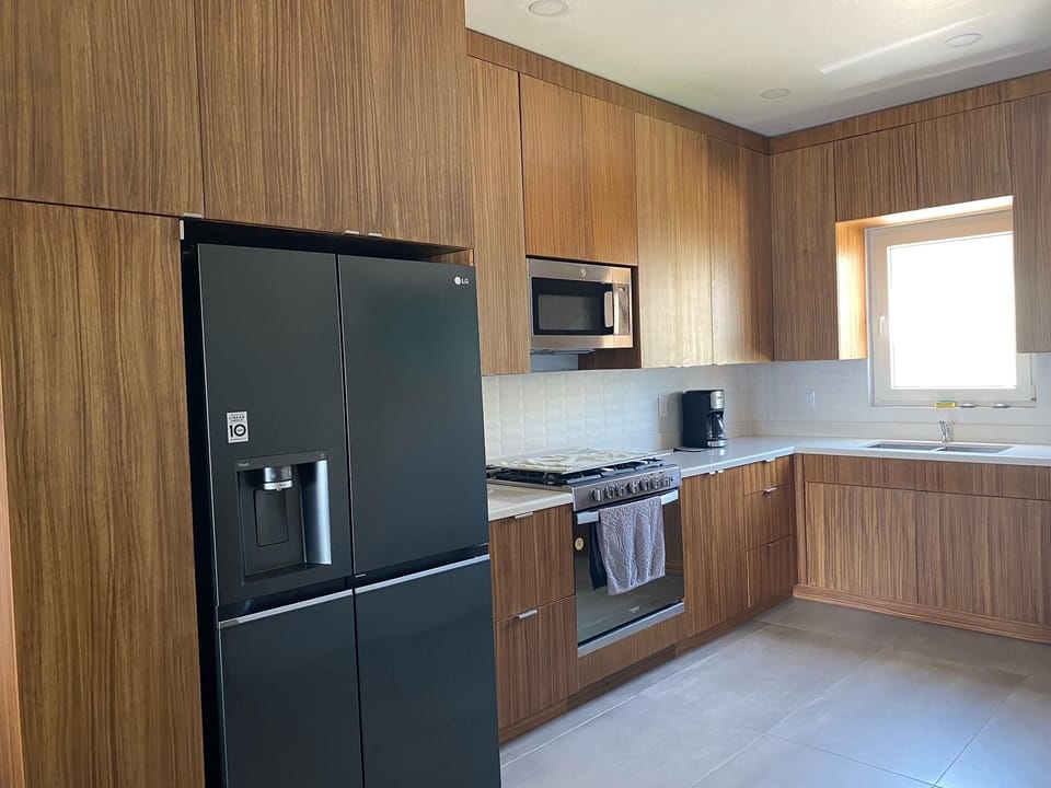 Spacious kitchen with modern appliances and natural light