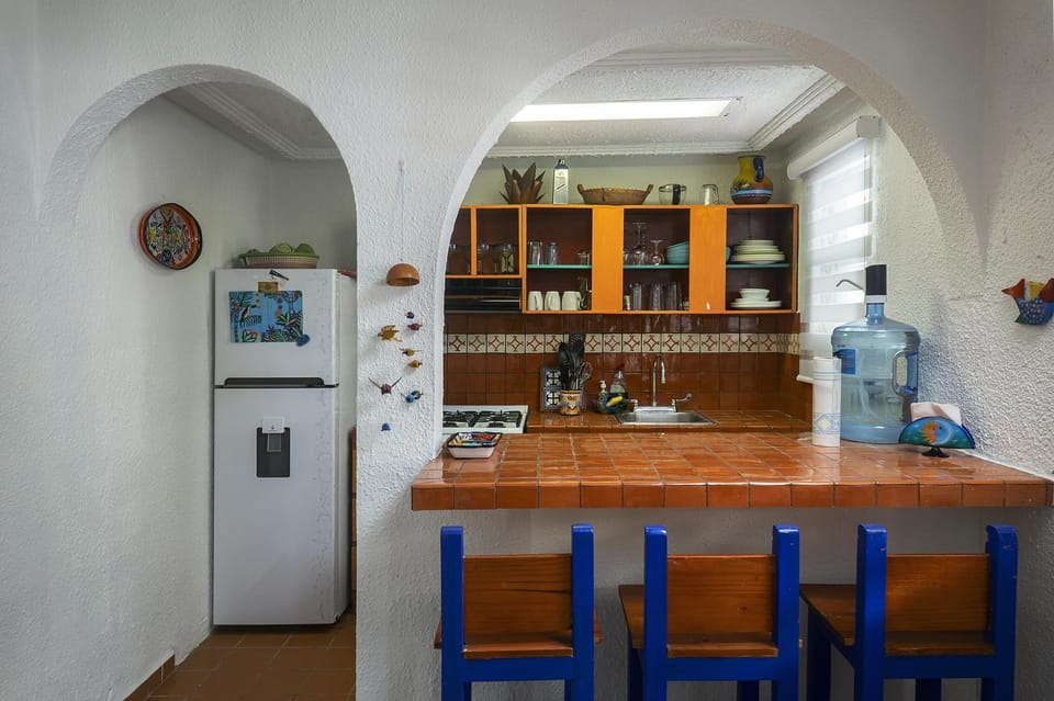Cozy kitchen with vibrant blue accents and warm wood countertops