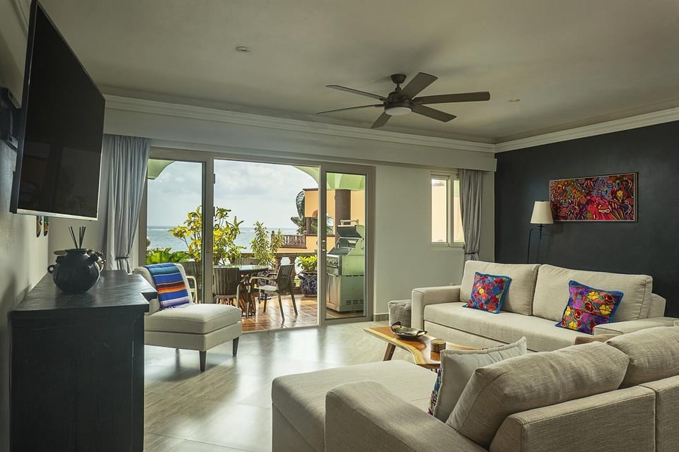 Spacious living room with cozy seating and garden views