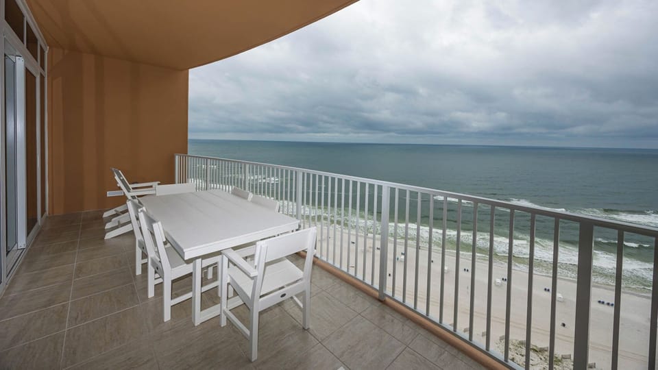 Take in the gulf view from the balcony while seated at the white table and chairs