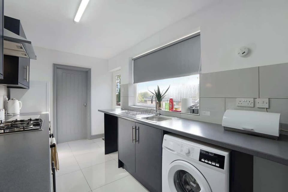 Kitchen equipped with all essentials, including a washer & dryer, oven, fridge and full cookware set.