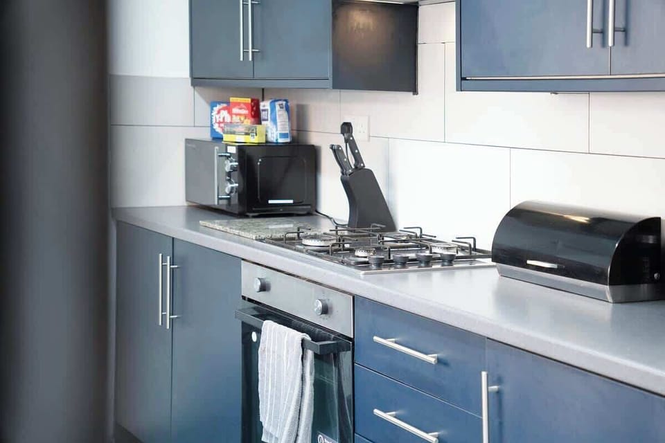 Kitchen equipped with all essentials, including a washer & dryer, oven, fridge and full cookware set.