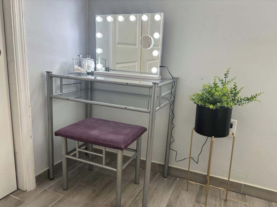 Get ready in style! Our vanity features a lighted mirror and comfy stool. Perfect for your morning routine.