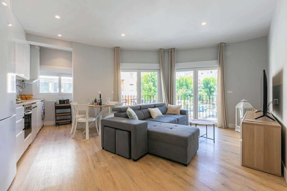 Spacious open living area with comfy sofa, kitchen, and dining for guests to enjoy.