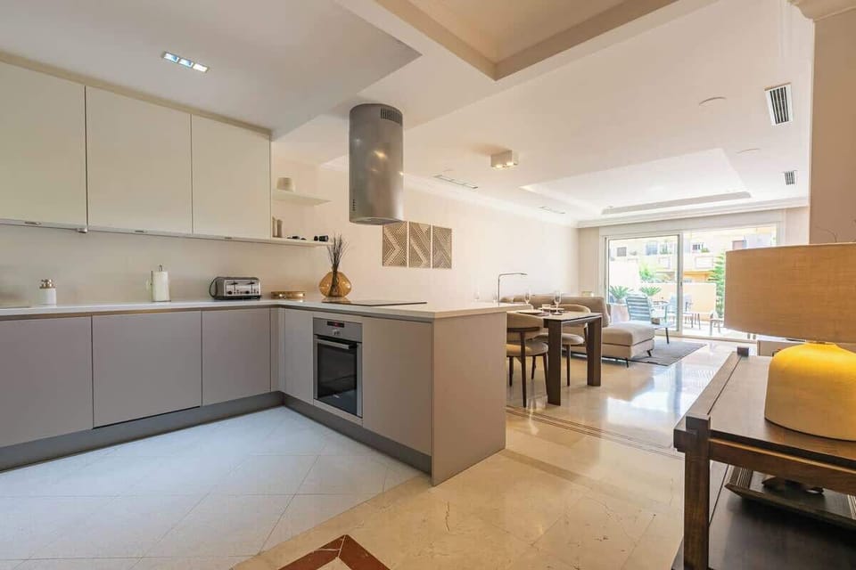Sleek, modern kitchen with ample space, stylish decor, and natural light—perfect for preparing meals and gathering.







