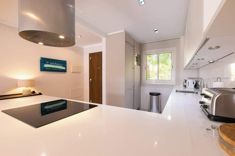 Sleek, modern kitchen with ample space, stylish decor, and natural light—perfect for preparing meals and gathering.







