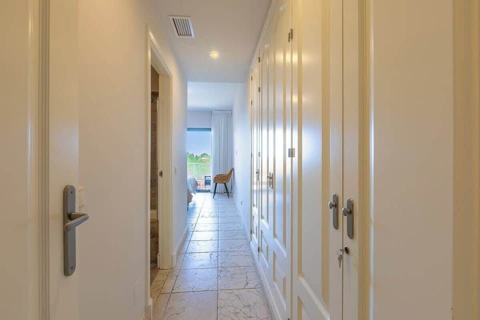 View of entrance to master bedroom. To the left the door to the ensuite bathroom. To the right a very large fitted wardrobs. Straight ahead the bedroom with access to the terrace.