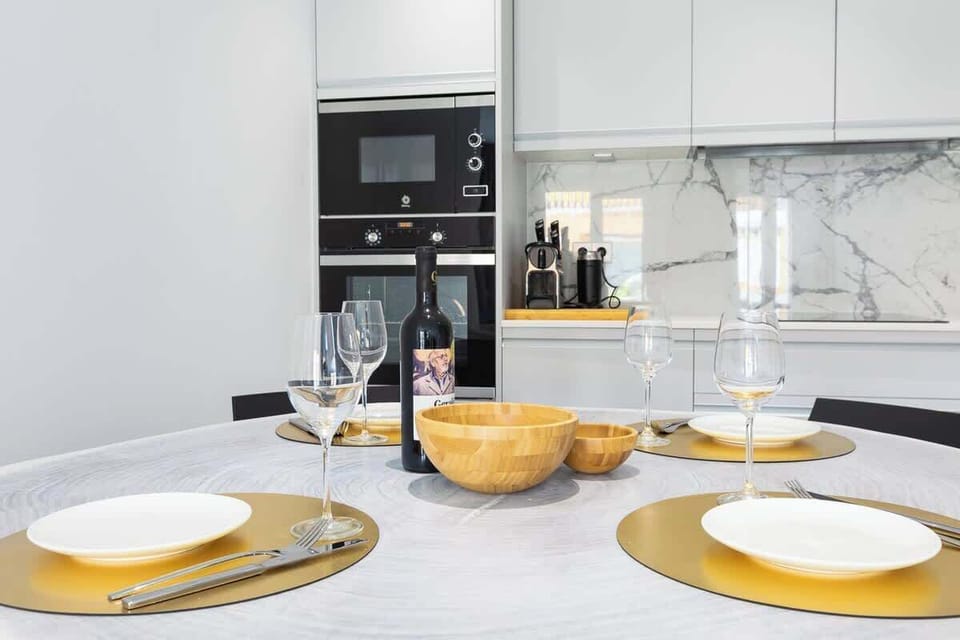 Open plan kitchen and living room. Fully equipped kitchen, comfortable sitting lounge with large glass doors leading to terrace which overlooks Marbella port and the beach.