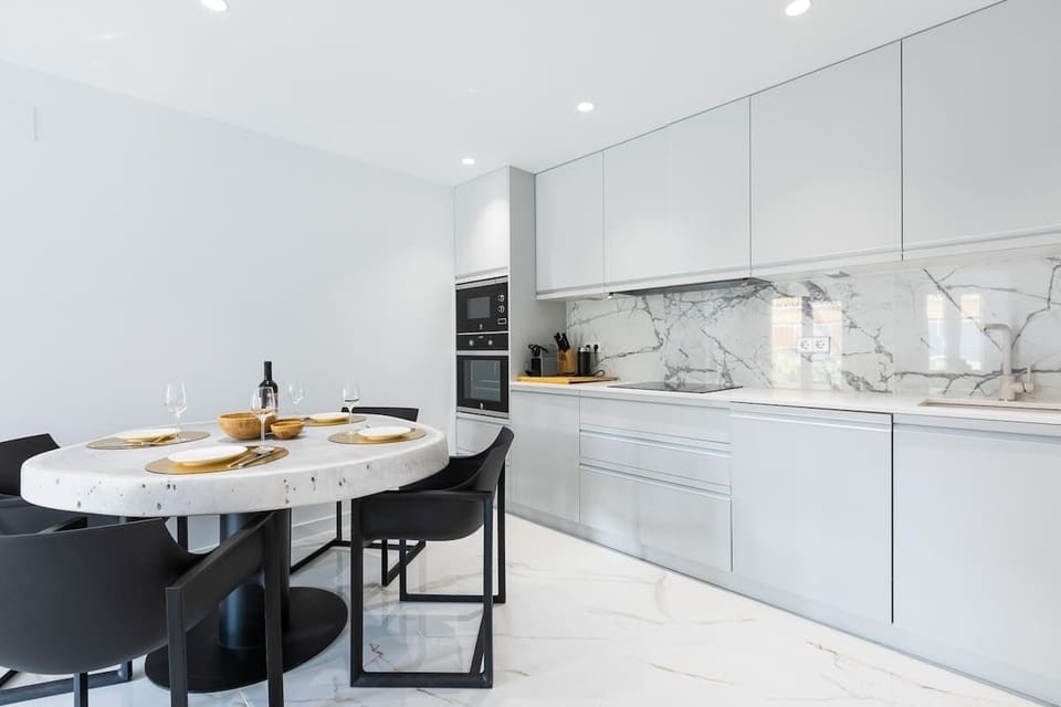 Open plan kitchen and living room. Fully equipped kitchen, comfortable sitting lounge with large glass doors leading to terrace which overlooks Marbella port and the beach.