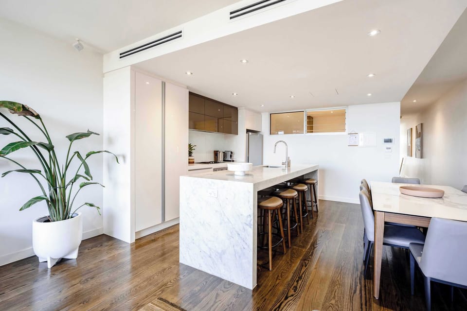 The kitchen island and dining table are designed in an open-concept layout.