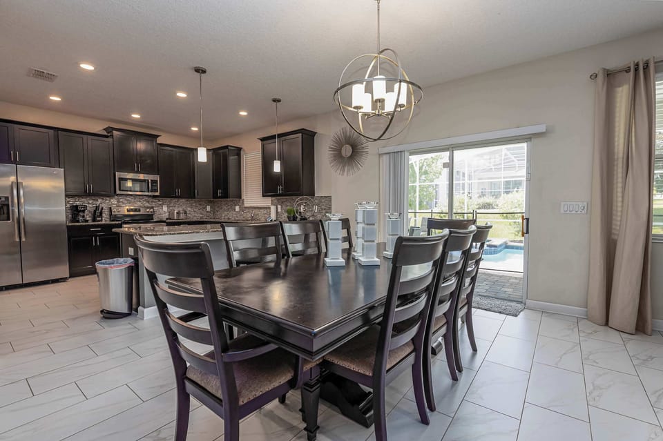 A table that can comfortably seat at least 8 with a view of the pool for a relaxed meal at home