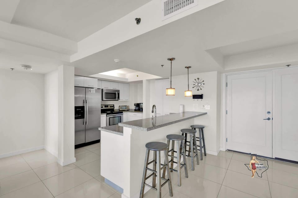 Cook up your favorite meals in this sleek kitchen with a breakfast bar.