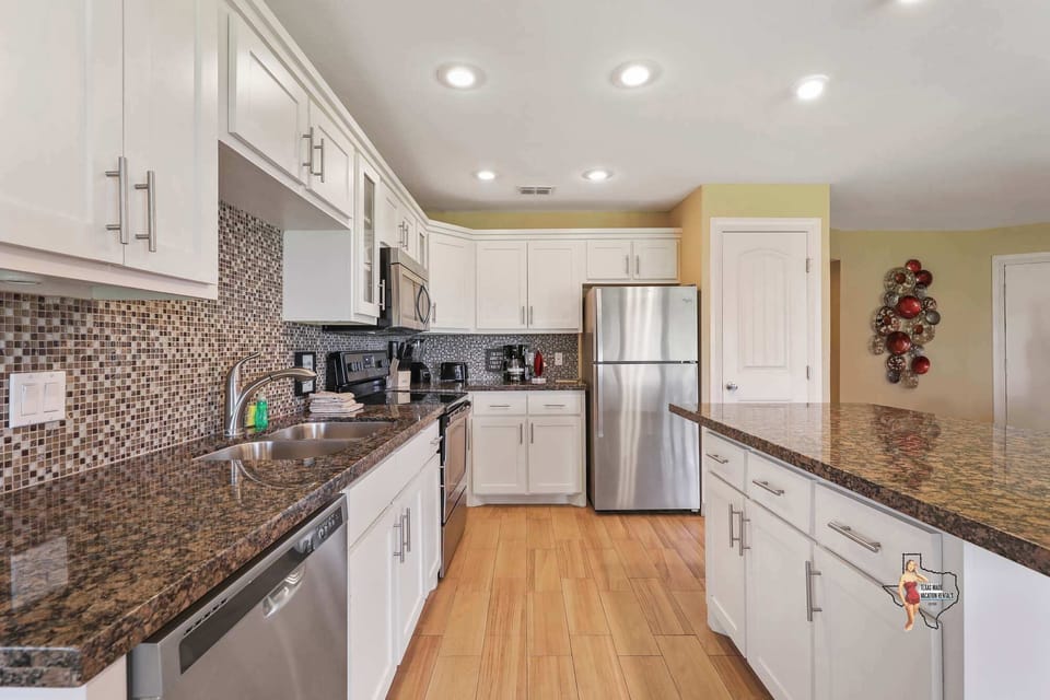 Fully equipped kitchen with granite countertops, modern appliances, and plenty of cabinet space for all your cooking needs.