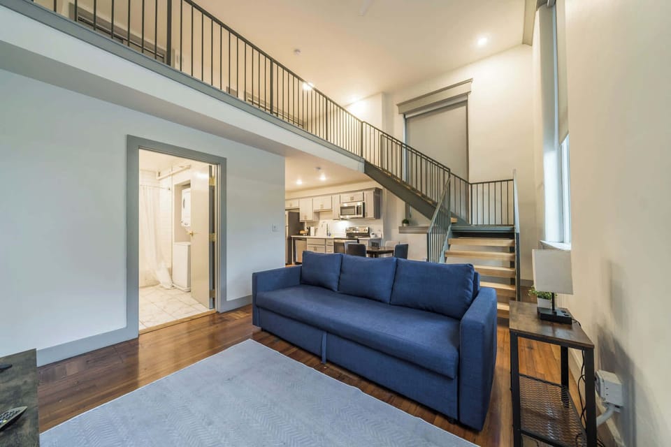 Living Room: Chic loft unit designed for both relaxation and productivity.