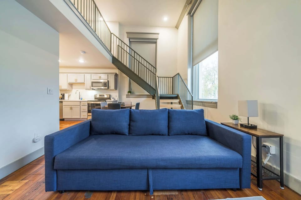 Living Room: Versatile sleep setup including a plush queen bed (bedroom 1) and a spacious queen sofa bed (living area) for ultimate relaxation.