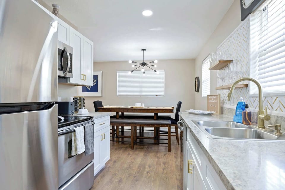 Modern kitchen with stainless steel appliances and a spacious dining area.