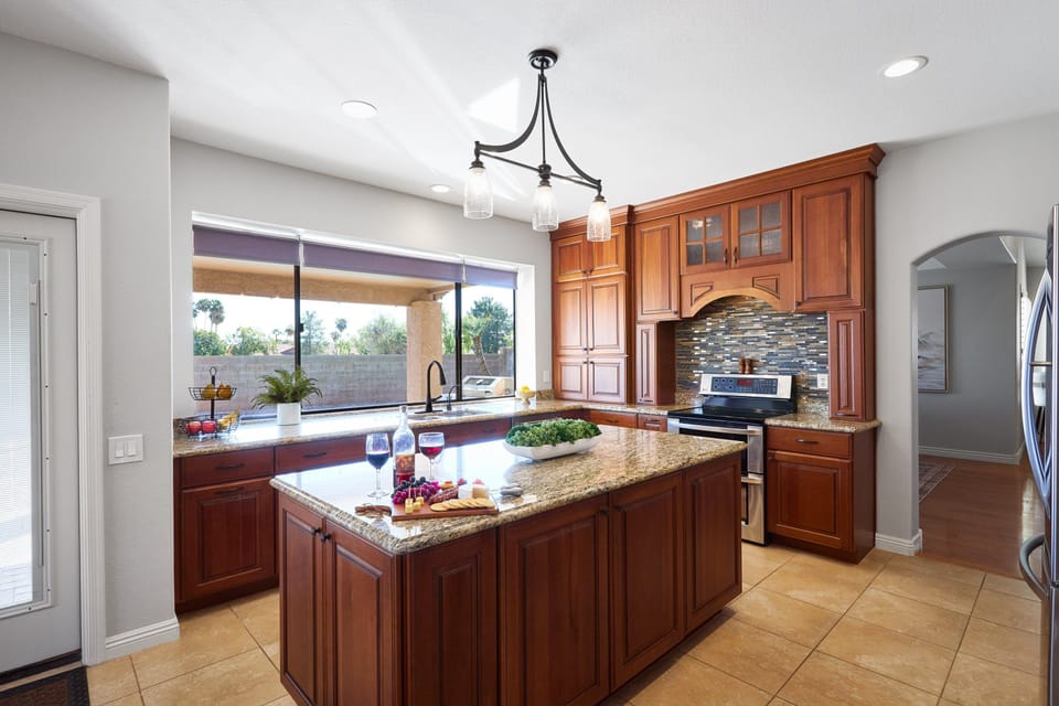 The fully equipped modern kitchen is stocked with all culinary essentials and stainless-steel appliances. (1st Floor)