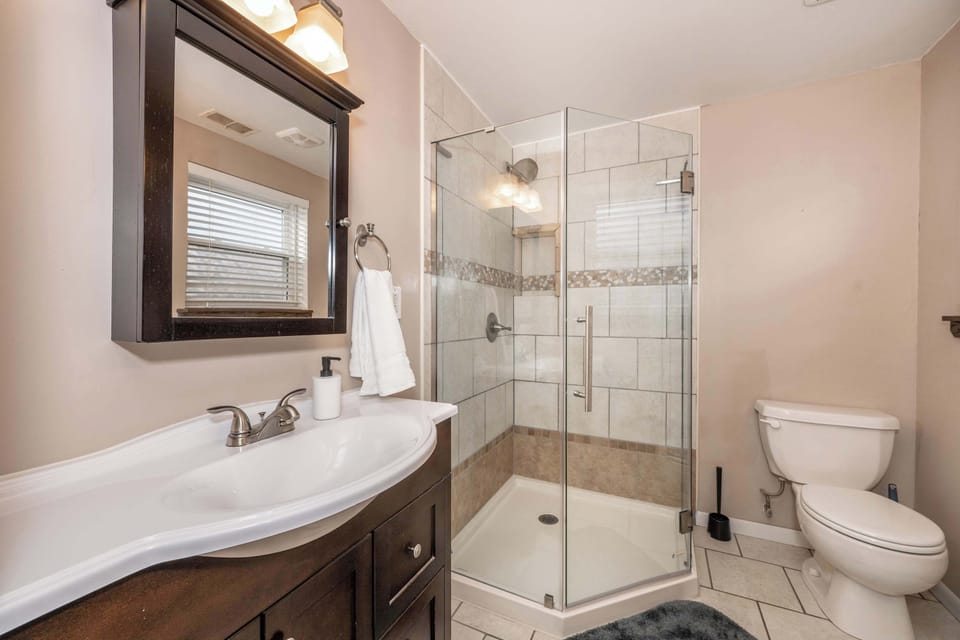 The master ensuite boasts dual vanities & a spa-like glass shower