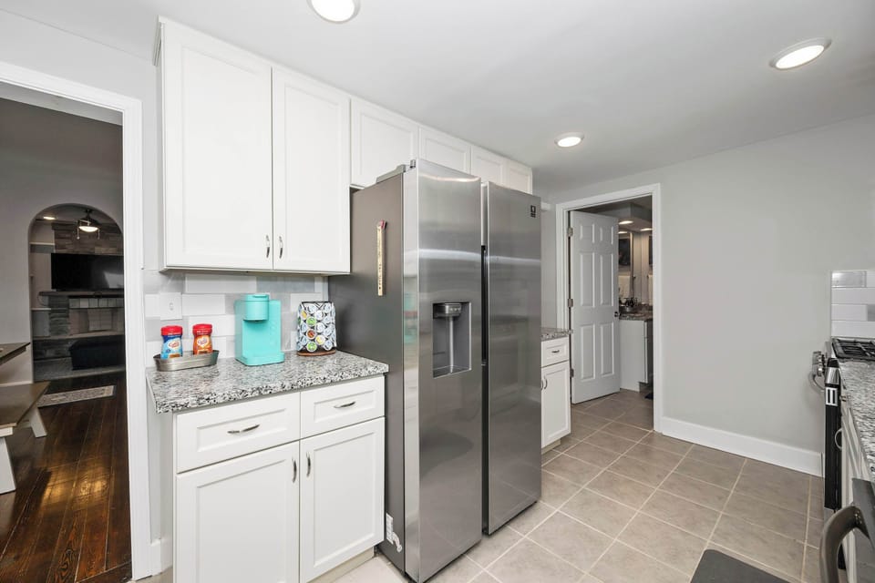 The bright, airy kitchen offers ample space & all the comforts of home