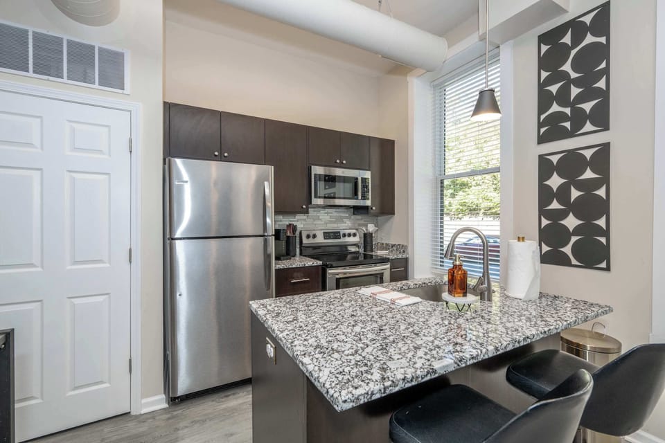 The sleek, open kitchen offers ample space & every home comfort