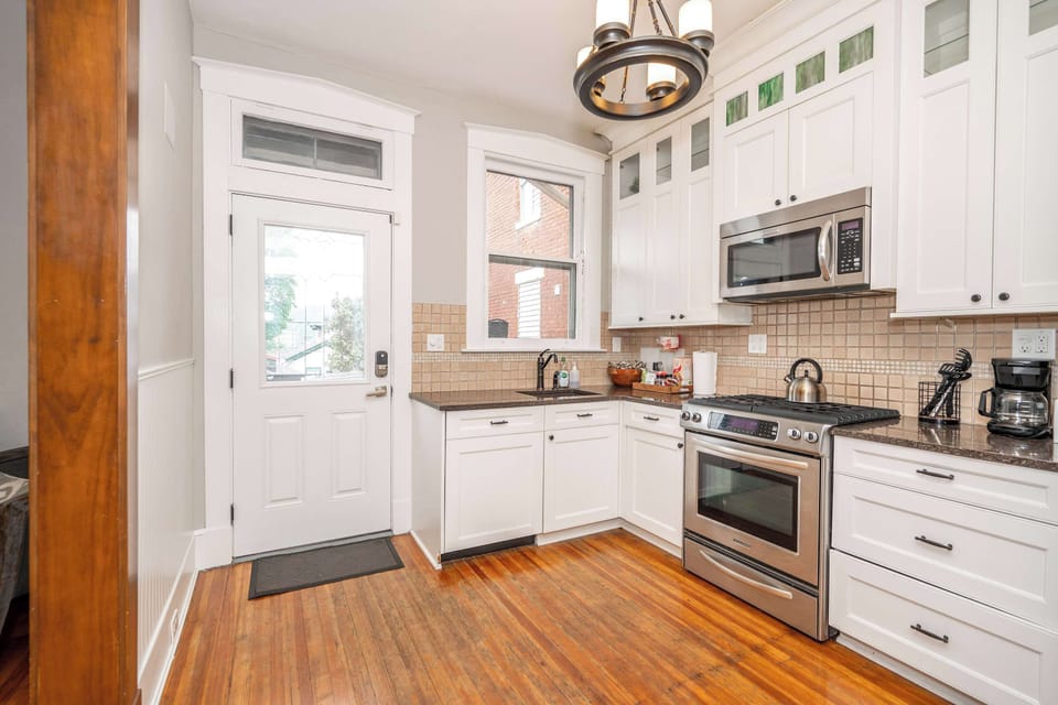 The chic kitchen offers ample space & all the comforts of home