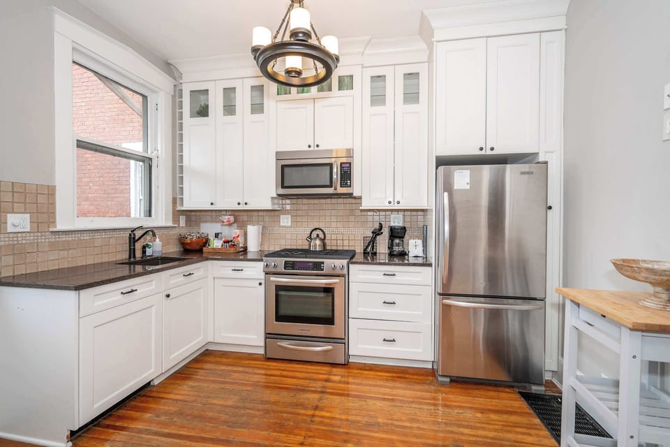 The chic kitchen offers ample space & all the comforts of home