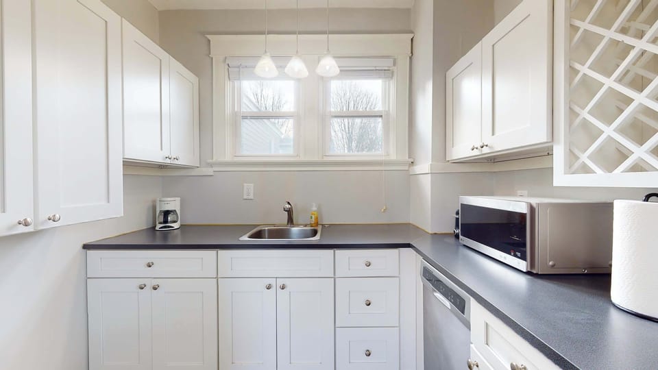 The bright, airy kitchen offers ample space & all the comforts of home