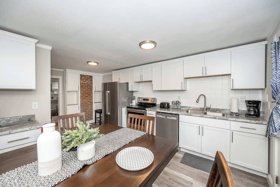 The bright, cozy kitchen offers ample space & all the comforts of home