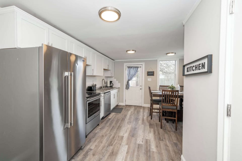 The bright, cozy kitchen offers ample space & all the comforts of home