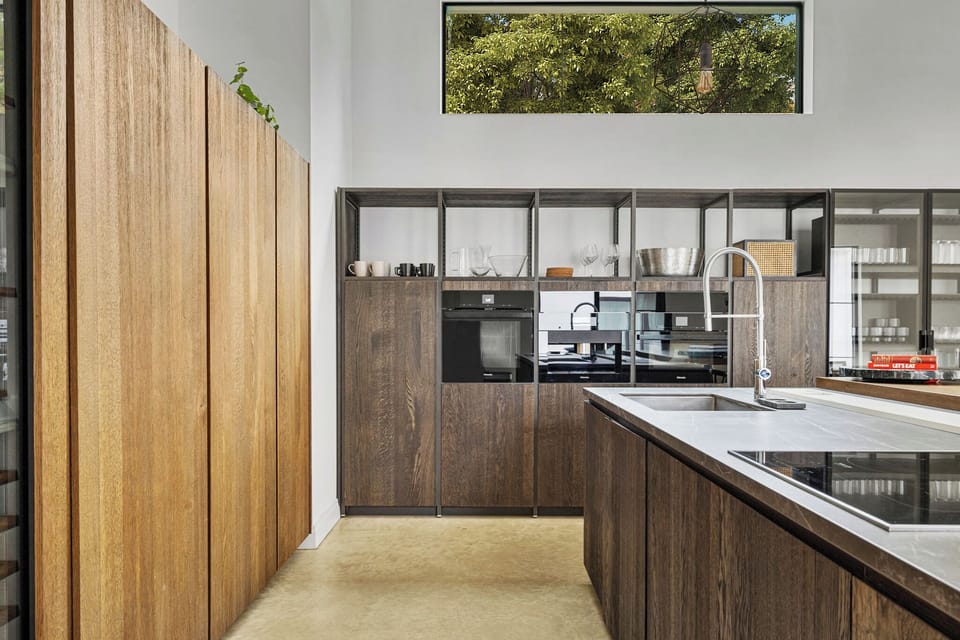 Your gourmet kitchen features sleek wood cabinetry and modern appliances, perfect for preparing memorable meals during your stay.