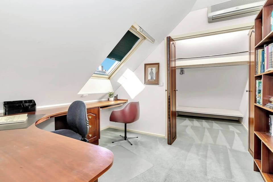 The unique upstairs office space is bright and airy, making it perfect for remote work, with an adjacent walk-in wardrobe for added convenience.
