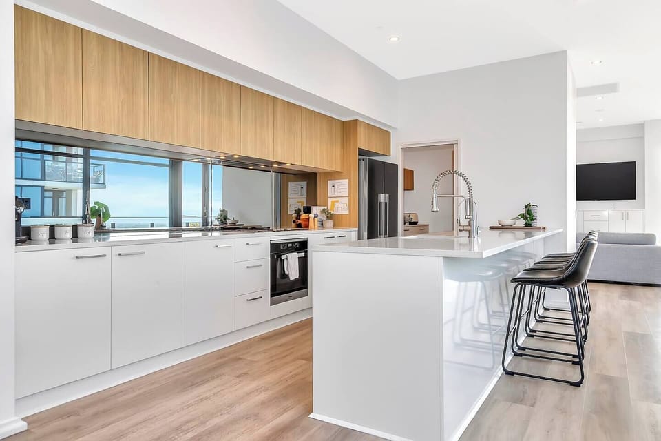 The sleek kitchen is fully equipped with modern appliances and a butler’s pantry, perfect for home-cooked meals.
