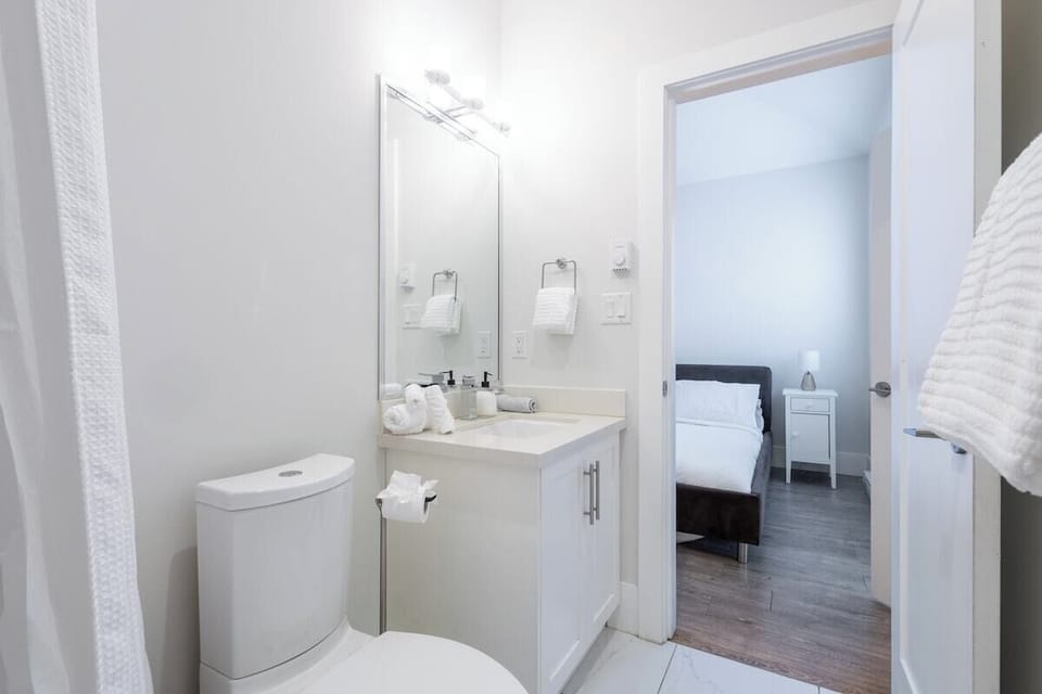 The modern bathroom offers a relaxing space with a bathtub, shower, and essential toiletries.