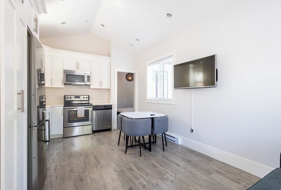 The living room's open design seamlessly blends comfort with modern amenities.