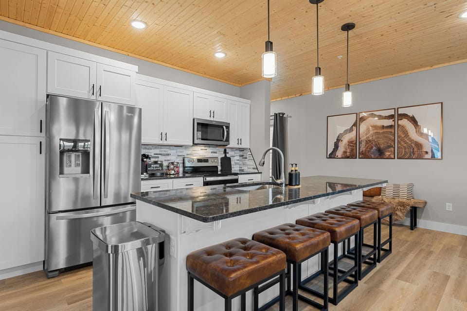 Fully stocked kitchen with large island and comfortable seating for 5