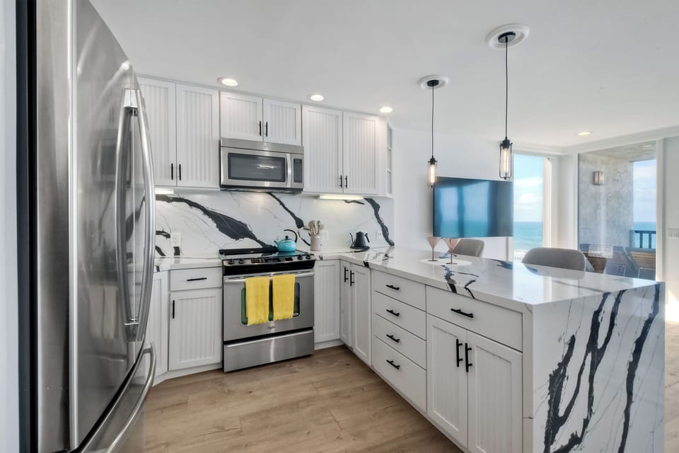 The chic, open kitchen offers ample space & all the comforts of home