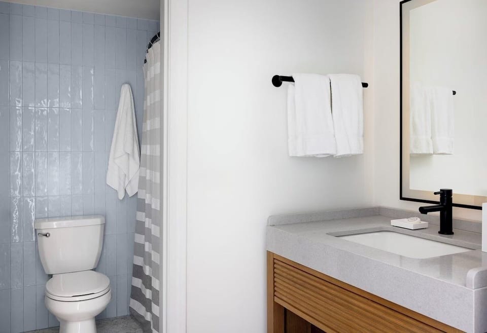 Refresh in a spotless bathroom with bright vanity lighting.