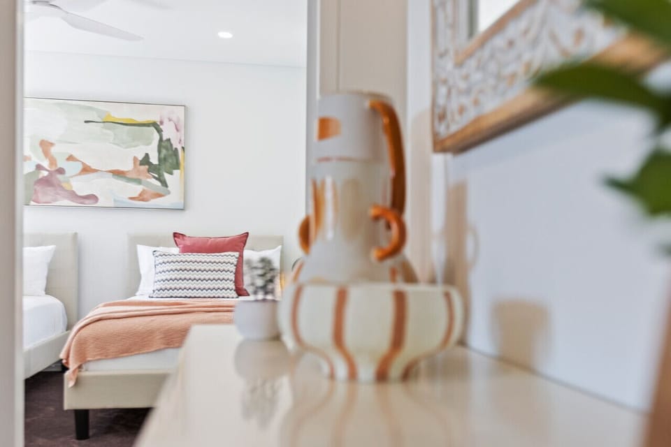 Guest Room: Bright art, plush pillows, and chic decor create an inviting atmosphere just for you!