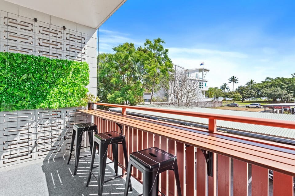 Balcony Oasis: Sip cocktails while enjoying lush views and vibrant tropical vibes!