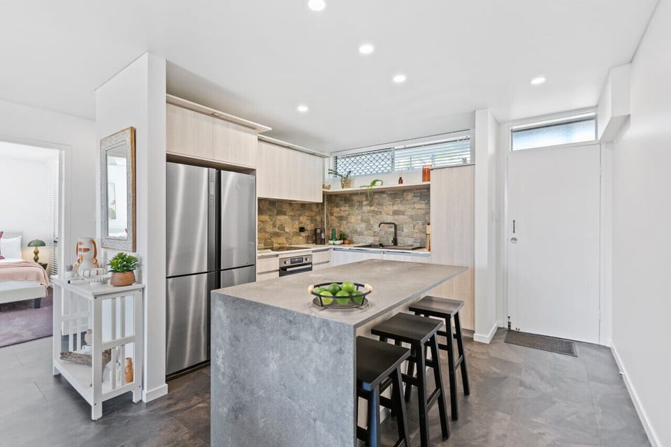 Modern Kitchen: Stylish space with stone accents and sleek appliances for culinary adventures!