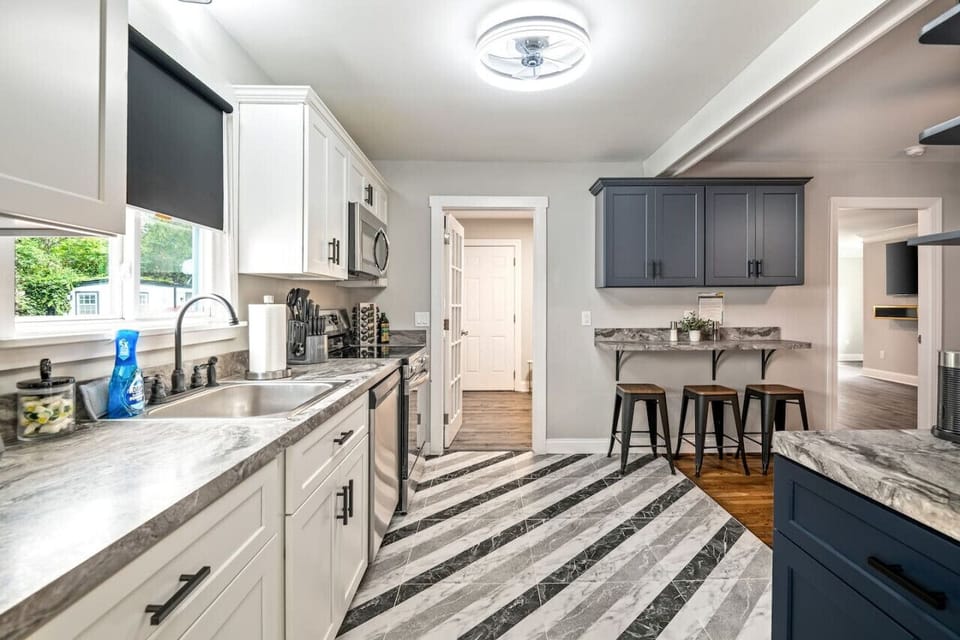 Whip up culinary delights in this fully-equipped, sleek kitchen. With a dishwasher, large fridge, stove, microwave, and plenty of counter space, meal prep is a breeze.