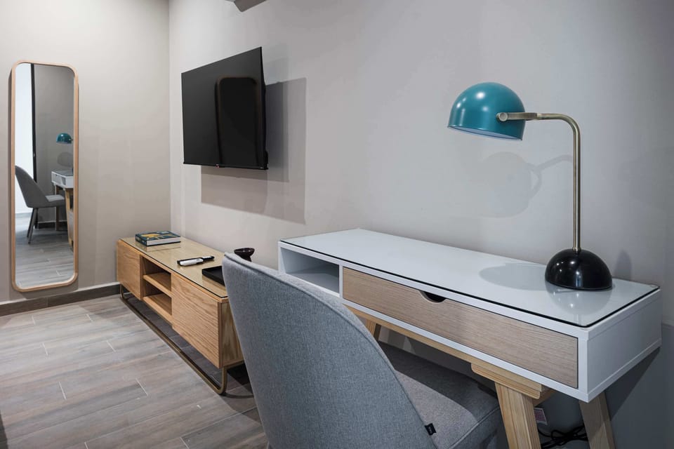 Work-from-home station, featuring a stylish desk and reading lamp.