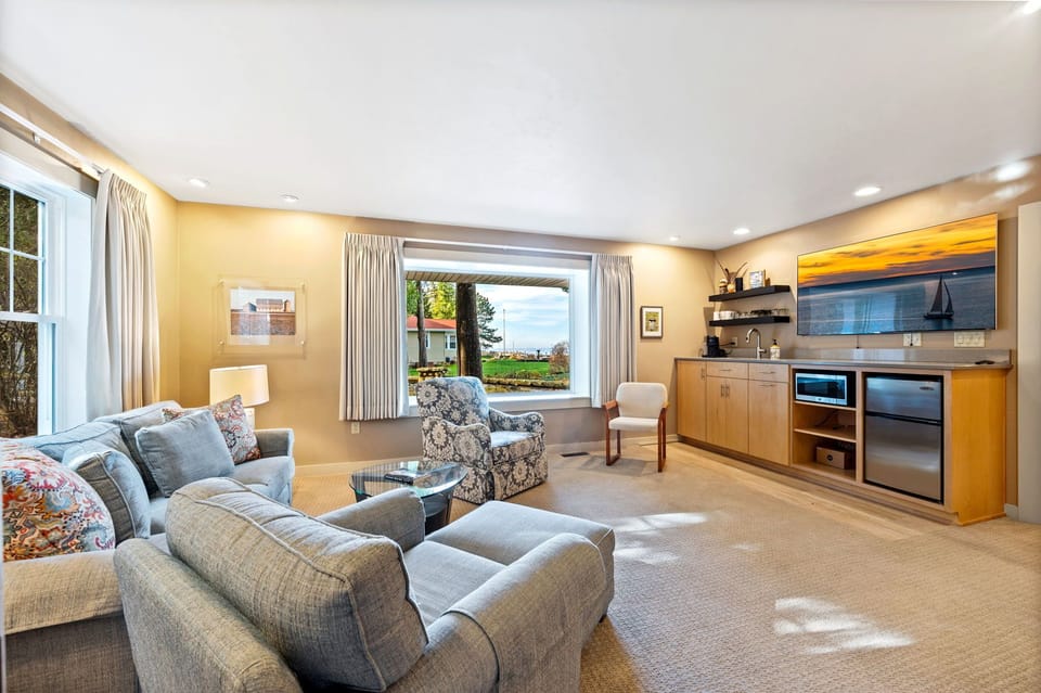 The master bedroom off the main entrance features a comfortable sitting area with a large TV and small kitchenette.